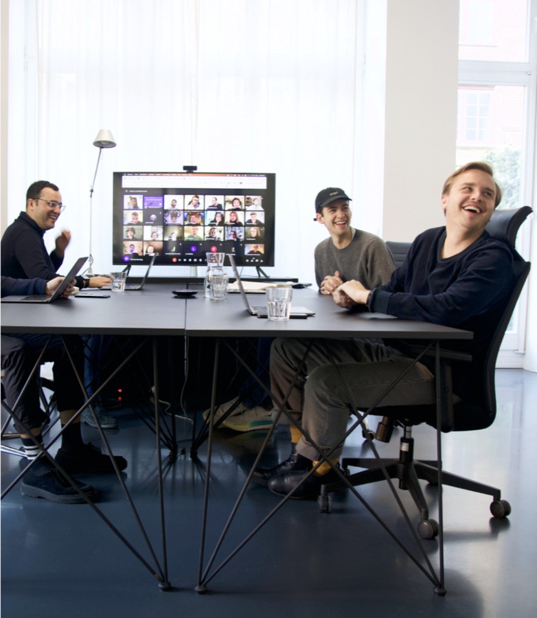 Team meeting with remote colleagues on screen